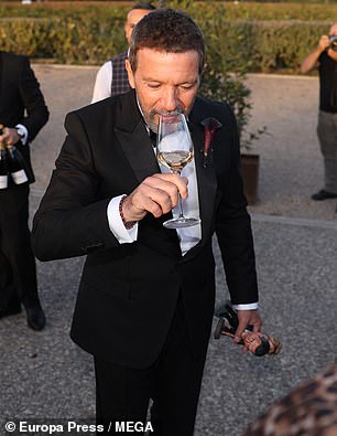 Glasses of wine were poured from bottles and passed around to others outside amid the festivities