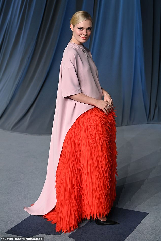 Elle Fanning donned a unique ensemble which comprised of pink caped material as well as a vibrant orange skirt