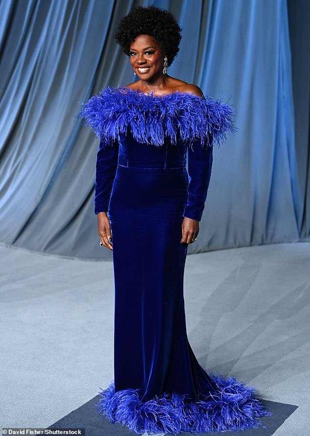 Viola Davis flashed a smile while sporting a blue velvet strapless gown with feathery details on the neckline