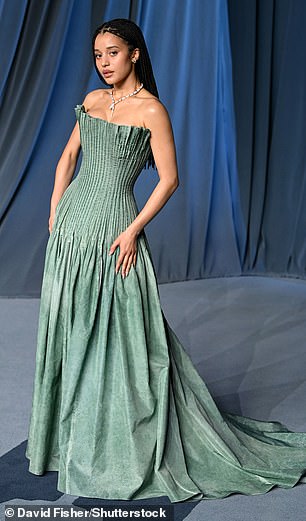 Chase Infiniti wowed wearing a strapless turquoise gown that had a structured bodice and skirt that fell down into a train