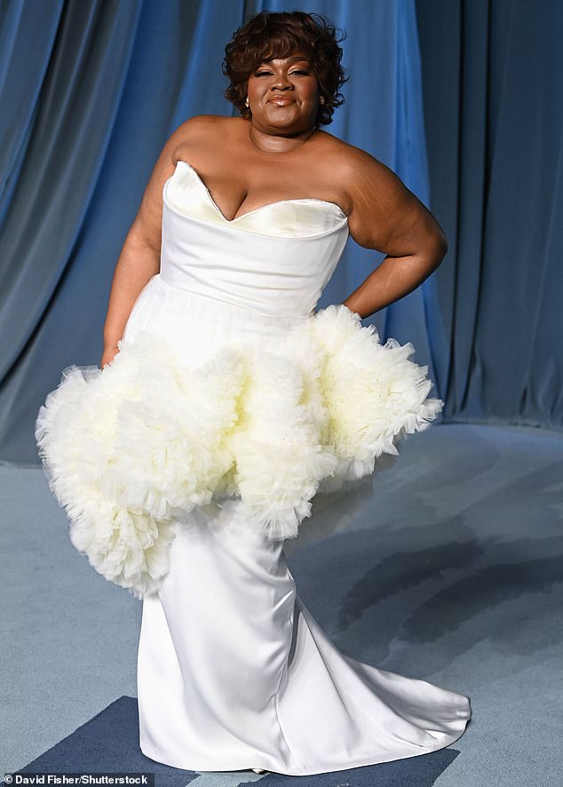Da'Vine Joy Randolph dressed to impress in a strapless white satin gown with ruffled tulle fabric around her lower waist