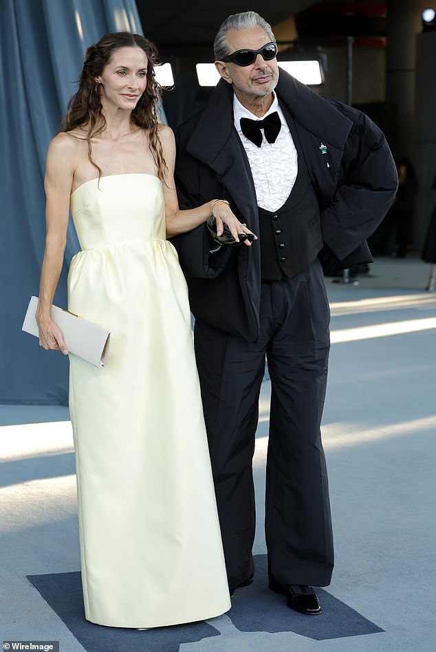 Jeff Goldblum showed off his sense style in a black puffer jacket as well as trousers and textured white shirt. He was seen with Emilie Livingston who donned a strapless off-white dress