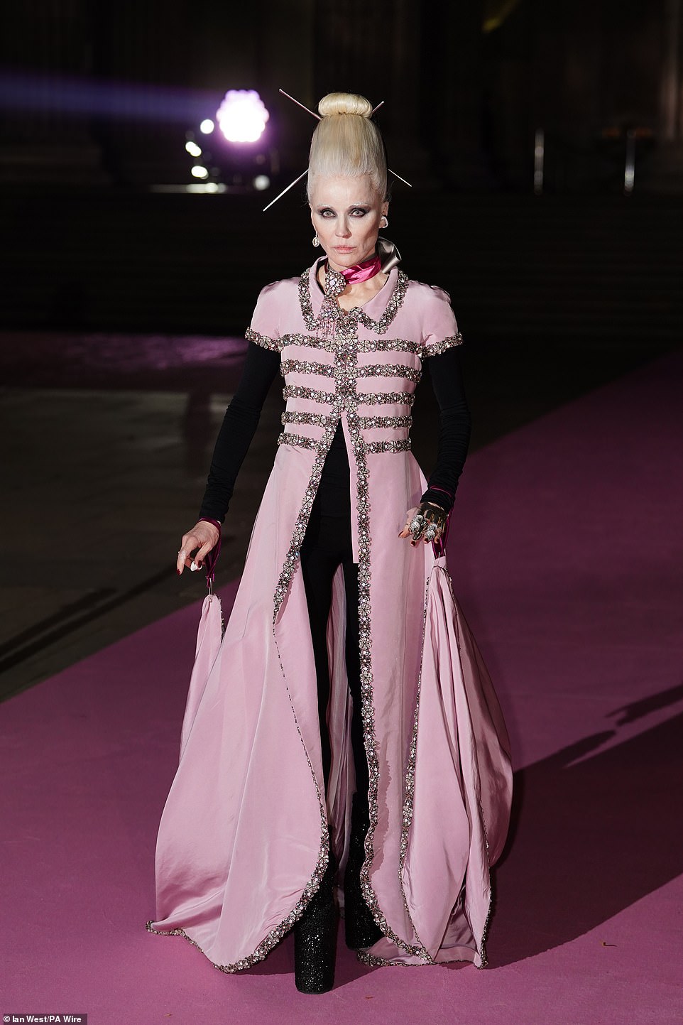 Fashion designer Daphne Guinness put on an eccentric display in a pink beaded skeleton-design shirt dress over a black long-sleeved jumpsuit