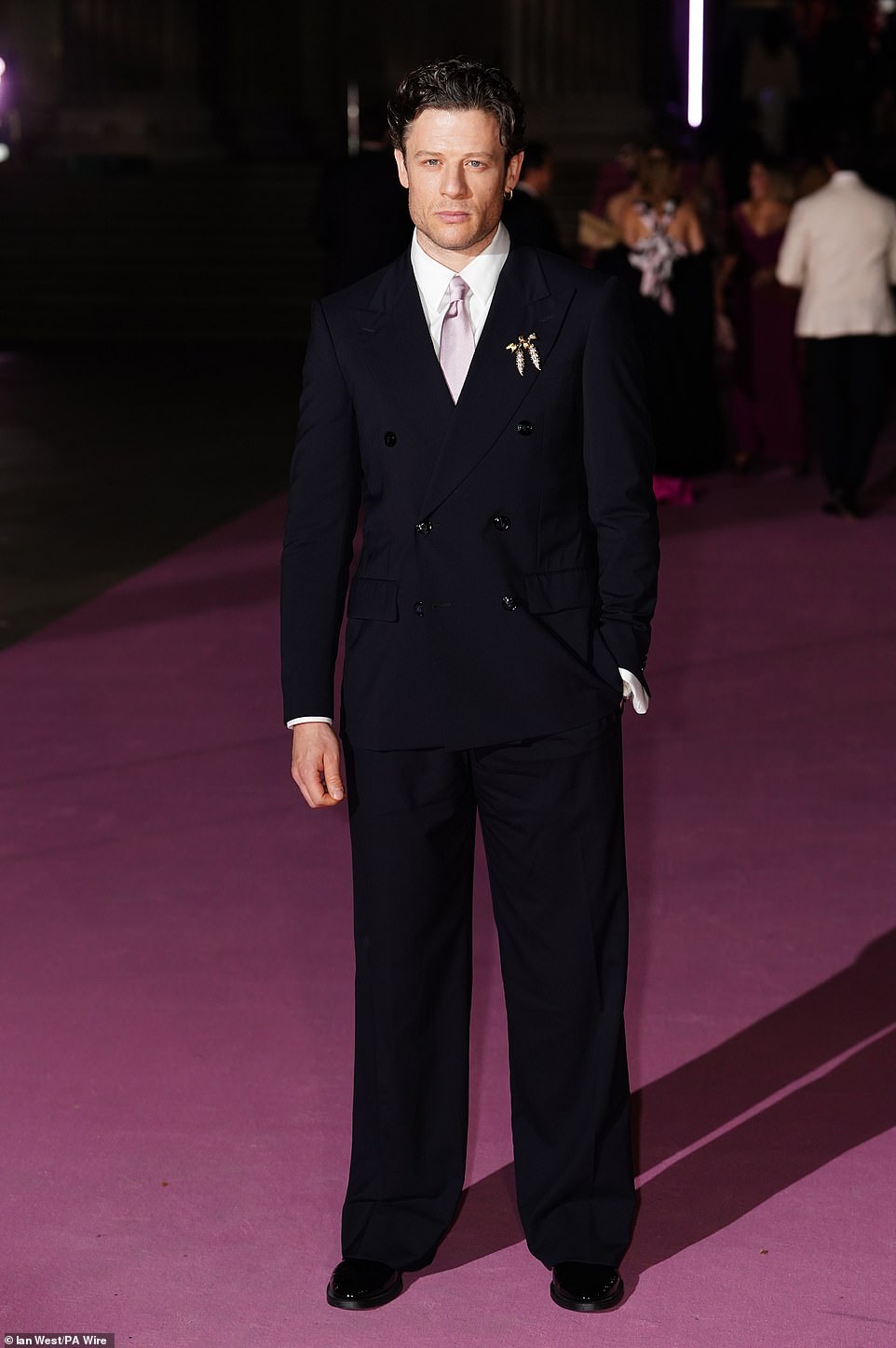 Meanwhile Happy Valley star James Norton opted for a black double-breasted suit with a gold brooch and a light pink satin tie