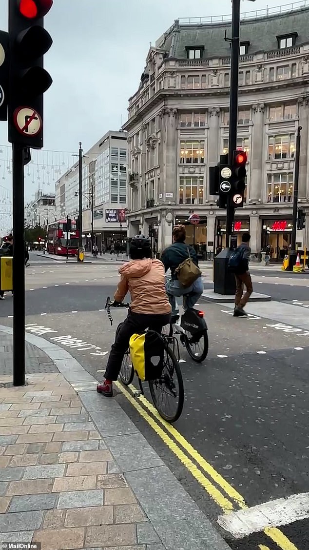 OXFORD STREET: Two cyclists decide to jump a red light in the heart of London