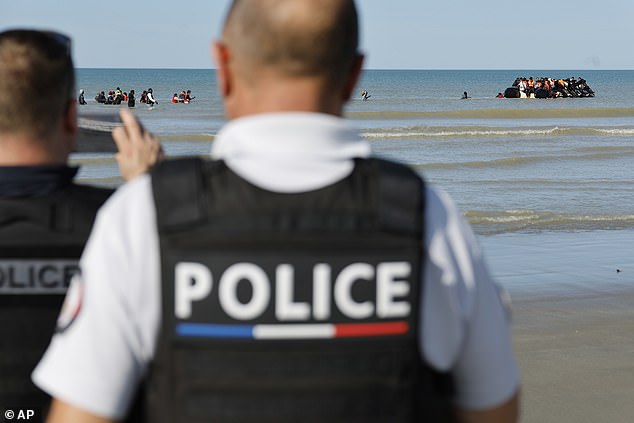 Britain's border security commander Martin Hewitt admitted to the Commons home affairs select committee the small size of the team dedicated to working on the deal. Pictured: French police officers take photos of migrants boarding a small boat to Britain from France on September 19, 2025