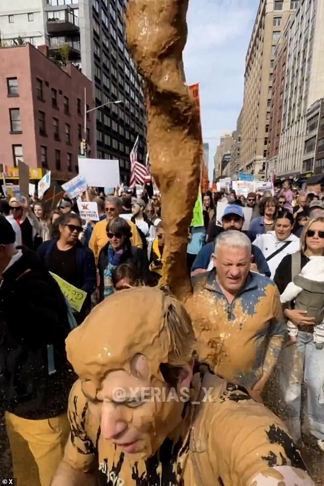 The plane hovers over 'No Kings' protestors marching through Times Square and bombs them with a brown liquid that appears to be faeces