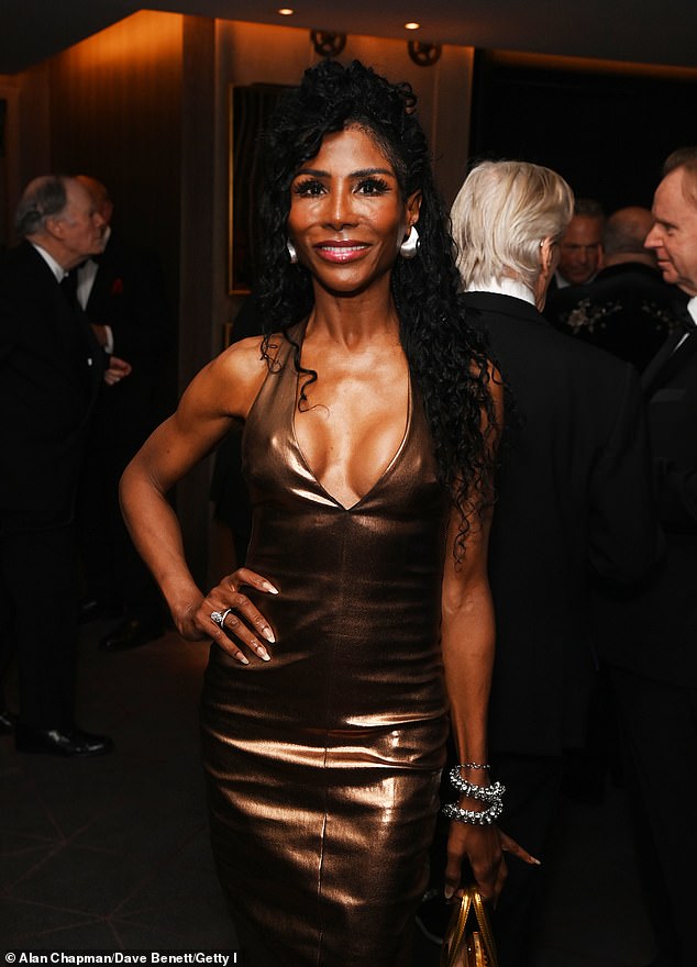 The singer put on a busty display in the midi dress with a plunging neckline