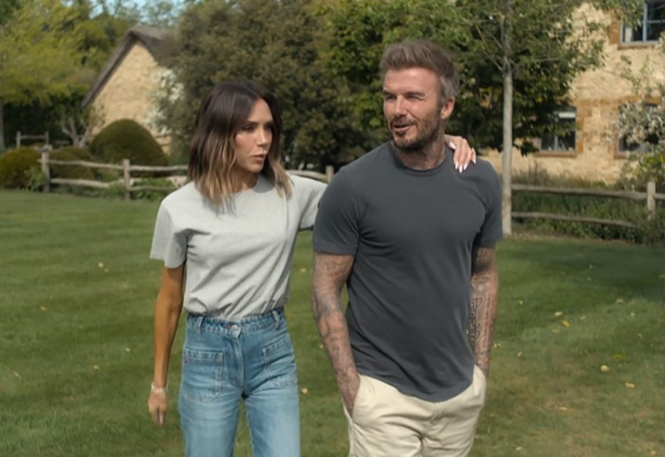 Victoria and David Beckham walking outside.
