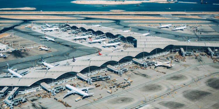 One dead after plane 'slides off runway and crashes into car' before plunging into sea at Hong Kong airport