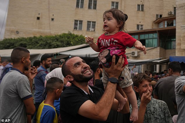 Palestinians celebrate following the announcement outside Al-Aqsa Hospital in Deir al-Balah, central Gaza Strip