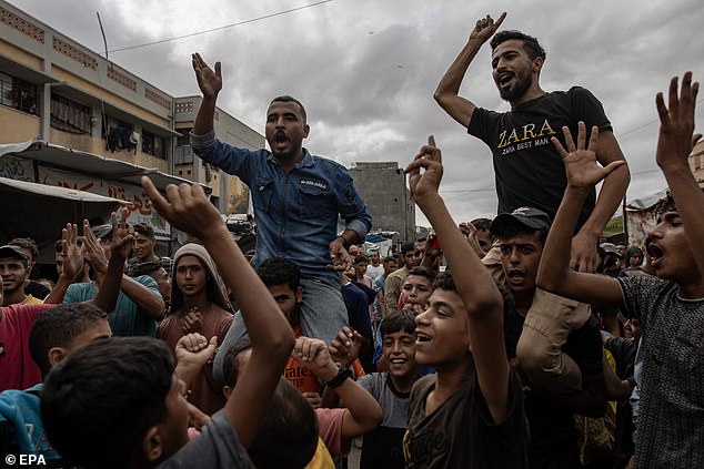 Palestinians celebrate the announcement of a ceasefire agreement between Hamas and Israel in Khan Younis, southern Gaza Strip