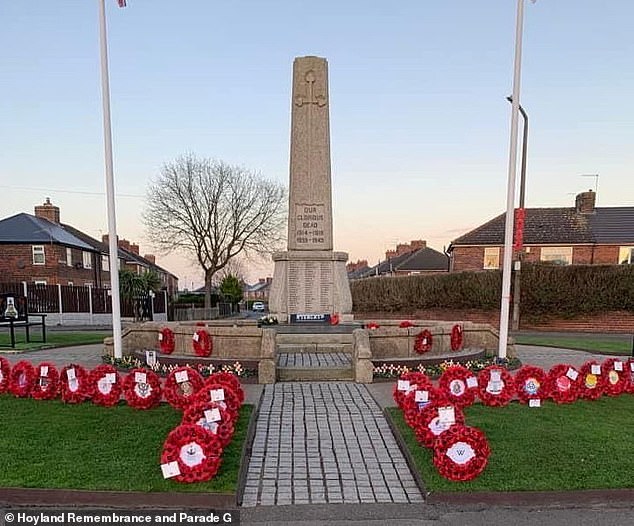 The group say they place over 350 wooden poppies to line the parade route, each carrying a name of a soldier commemorated on the Hoyland War Memorial (pictured)