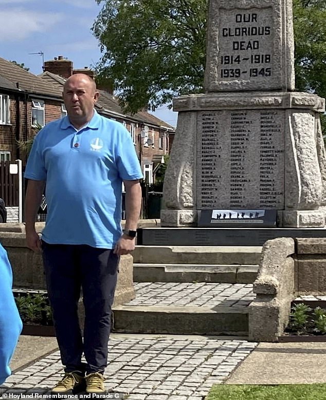 Robert Hill, Chair of The Hoyland Remembrance and Parade Group (HRPG), standing in front of the Hoyland War Memorial