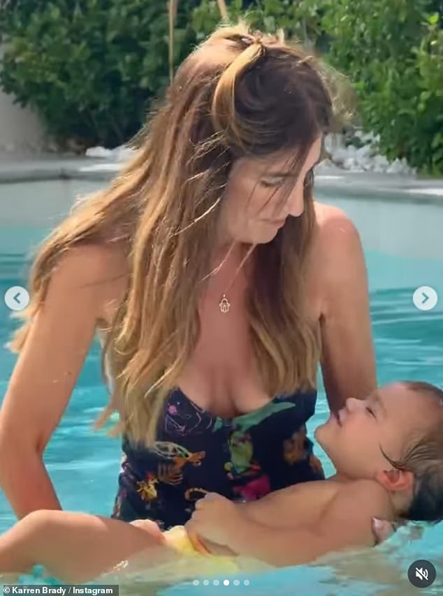 The Apprentice star, 56, looked worlds away from her old self as she slipped into a plunging backless navy swimsuit as she held her daughter Sophia Peschisolido's son Leo