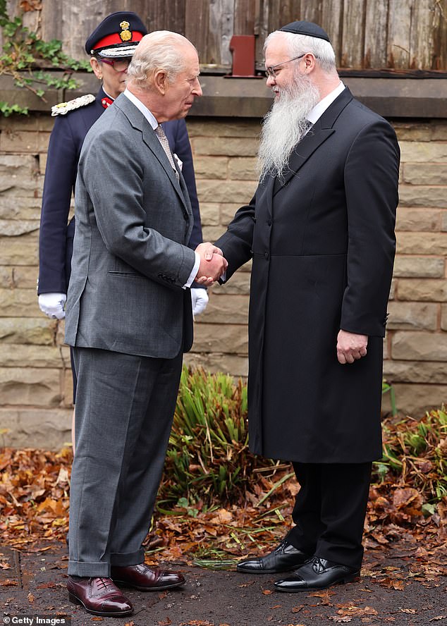 King Charles III is greeted by Rabbi Daniel Walker during a visit to Heaton Park Hebrew Congregation Synagogue in Manchester today to show his support for the Jewish community