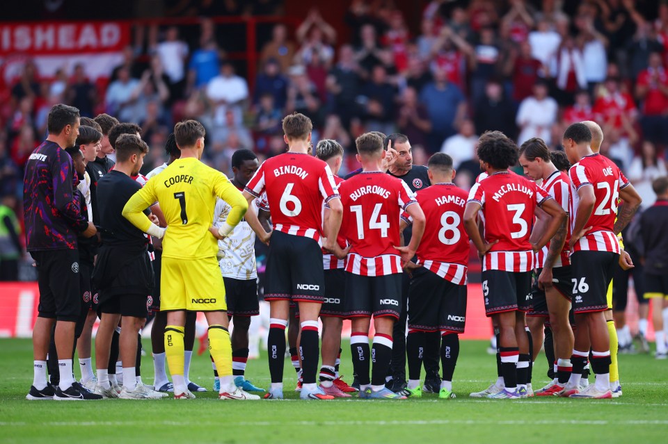 Sheffield United players listening to their coach.