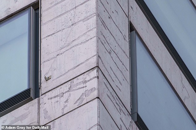 Another close-up shows stains and apparent cracks on the building's exterior this month
