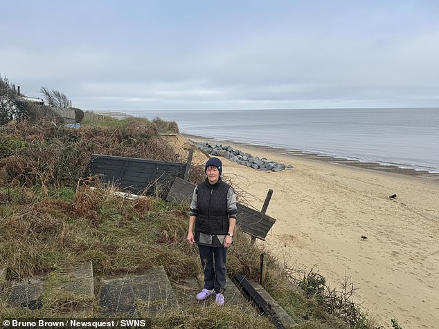 Pascal Rose pictured on top of the cliff outside of her home, which is along a stretch of coast exposed to erosion
