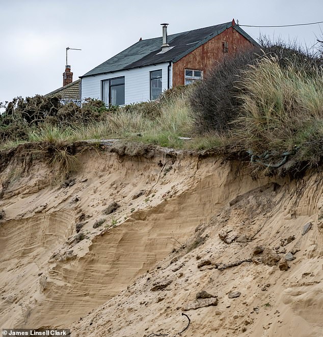 A house in the area pictured teetering on the edge of a cliff. Homes such as this are being flogged for low prices by estate agents