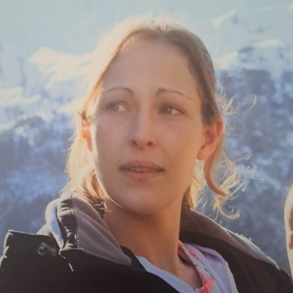 Joanna Hills looking toward the right with mountains in the background.