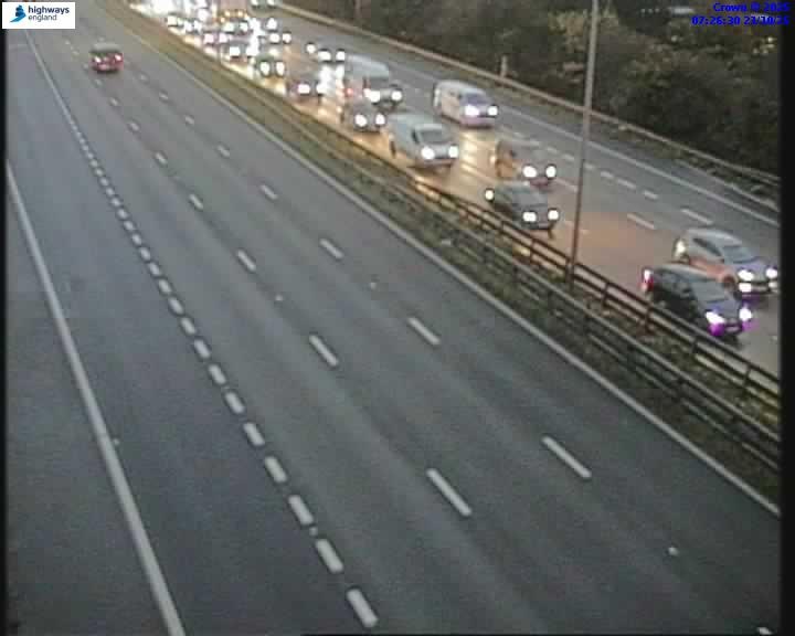 Live traffic camera image of M62 with heavy traffic and delays.