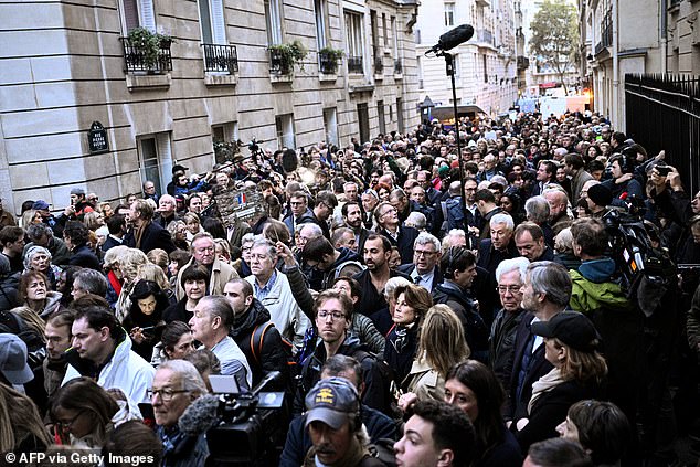 Supporters of France's former president Nicolas Sarkozy gather outside his residence ahead of his departure to La Sante prison for incarceration on a five-year prison sentence