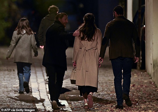 Jean Sarkozy (2ndL) and Pierre Sarkozy (R), sons of France's former president Nicolas Sarkozy, arrive at their father's residence ahead of his departure to La Sante Prison