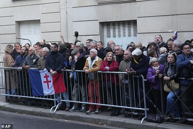 People gather outside former French President Nicolas Sarkozy's home, Tuesday, October 21, 2025 in Paris