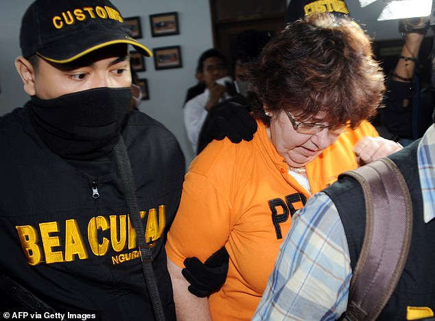 Lindsay June Sandiford being escorted by an armed customs personnel at a customs office in Denpasar on Bali island on May 28, 2012