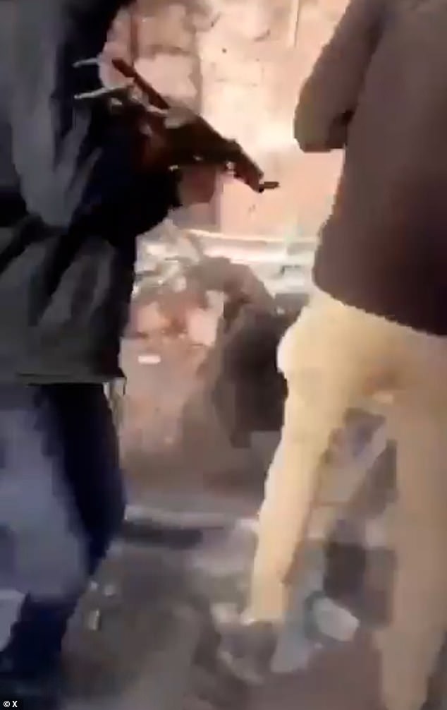 The clip captured alleged masked Hamas militants shooting at two bound civilians on the ground after being beaten