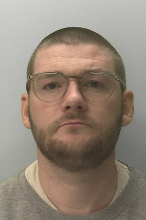 Mugshot of Ricky Stubberfield, a man with glasses, a beard, and short hair, facing forward.