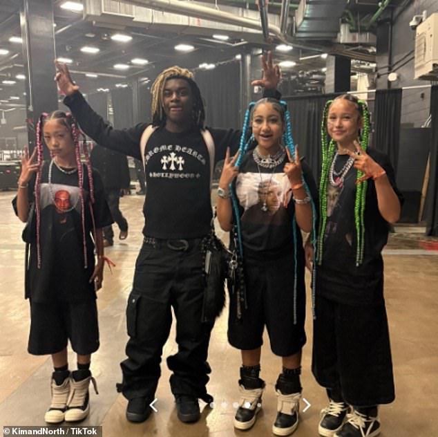 North donned a slew of eye-popping silver necklaces a black oversized tee, baggy shorts and chunky sneakers