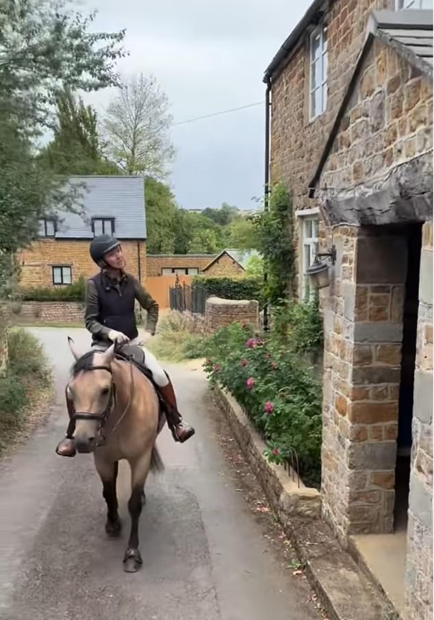 De Rossi seen here riding her horse into town as she models a helmet and boots