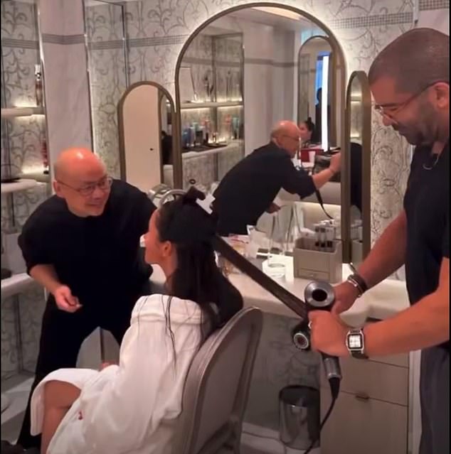 She also showed how she got ready for Paris Fashion Week, as her team helped her with hair and makeup - while her makeup artist, Daniel Martin, quietly deleted a video detailing the exact cosmetic products that he used on her