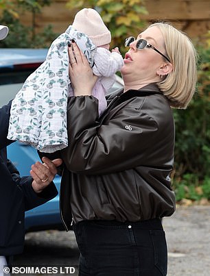 The pair ensured the child was covered by her blanket on a chilly day in the English capital