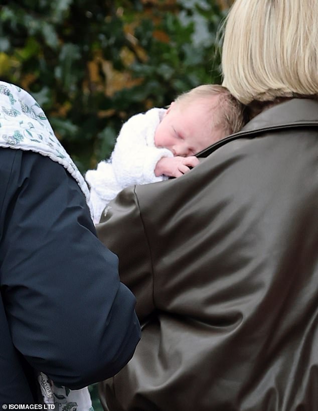 Holland slept on her mother's shoulder as they made their way into a local restaurant