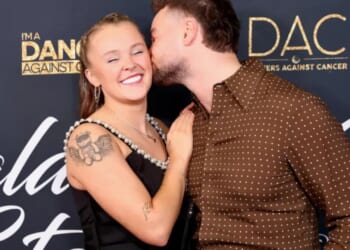 JoJo Siwa and Chris Hughes look more loved up than ever at charity event