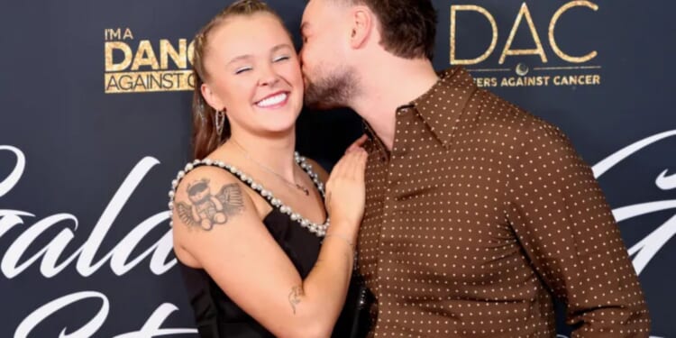 JoJo Siwa and Chris Hughes look more loved up than ever at charity event