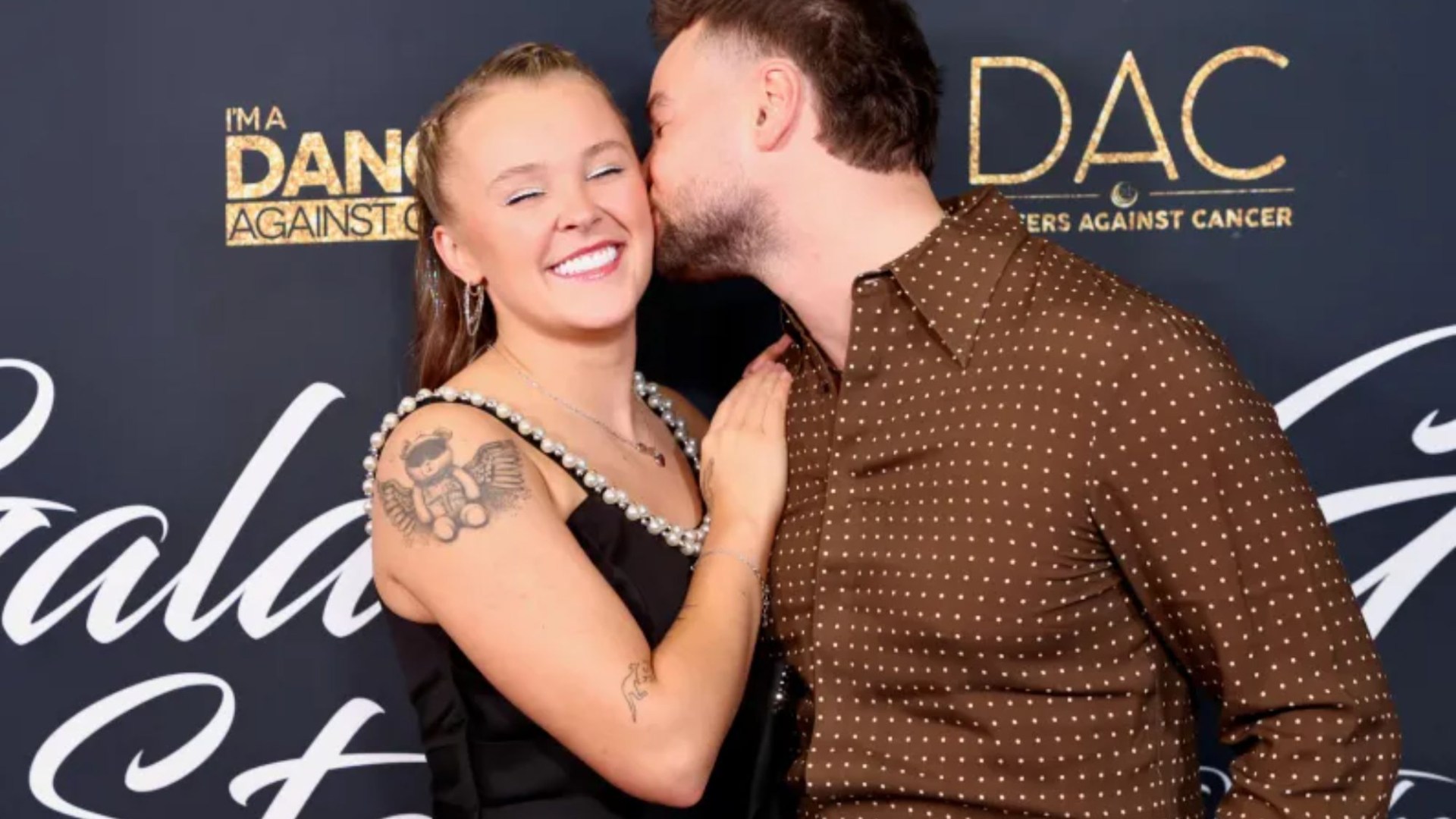 JoJo Siwa and Chris Hughes look more loved up than ever at charity event