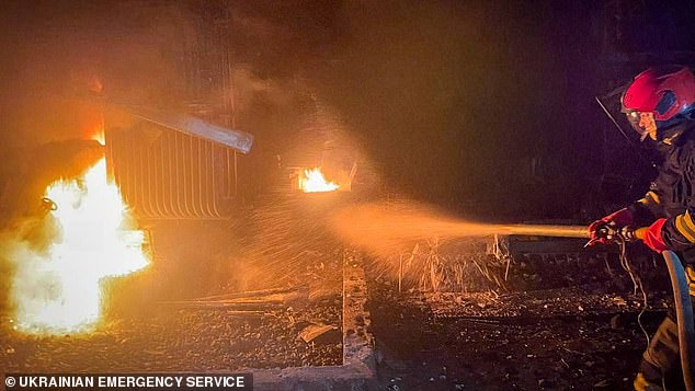 A firefighter working to extinguish a blaze after the strikes. It is feared that hits on Ukraine's power infrastructure would plunge many Ukrainians in the dark throughout the winter months