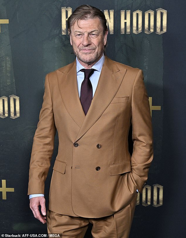 Dressed in a tobacco brown suit, Bean looked the part while posing for photos on the red carpet shortly after arriving at the Hollywood venue