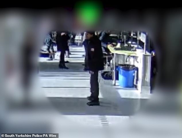 Khan in the school canteen with a knife shortly after he killed Harvey in Sheffield on February 3