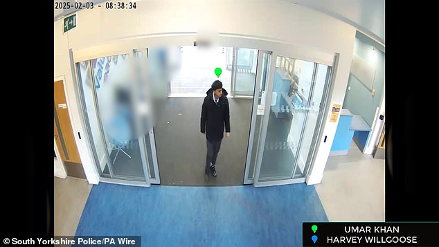 Khan is seen walking through the All Saints Catholic High School entrance on the morning