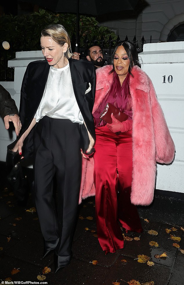 Naomi wore a silk black suit and smart white top