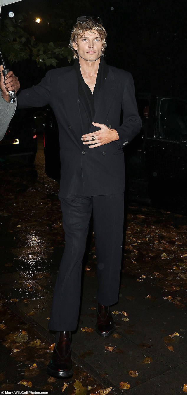 Model Jordan Barrett looked as smart as always in a black suit