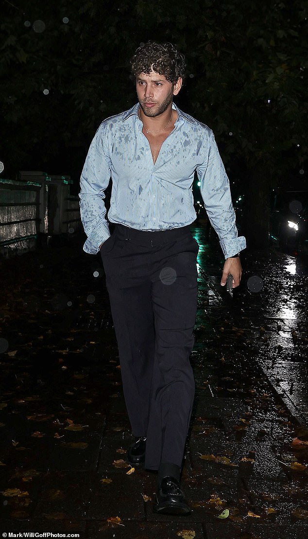 Love Island's Eyal Booker was in need of an umbrella as he arrived to the house