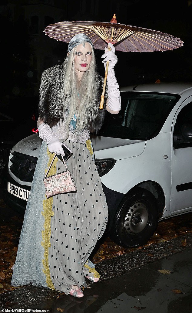 Model Kristen McMenamy wore a grey dress and fur coat