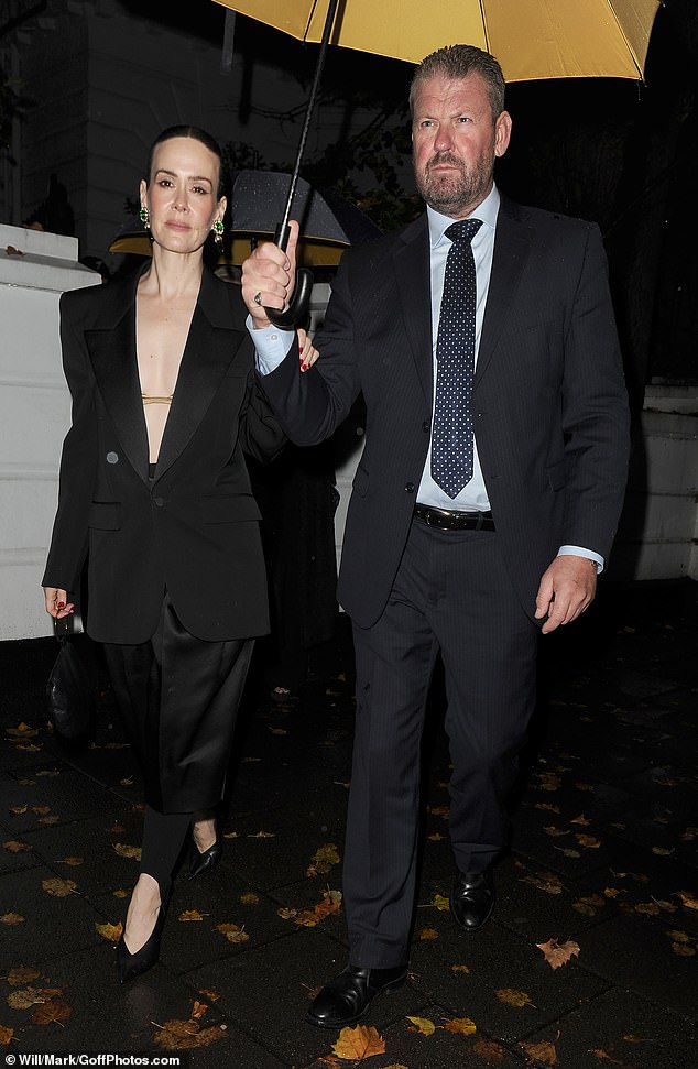 She shielded herself from the rain with an umbrella