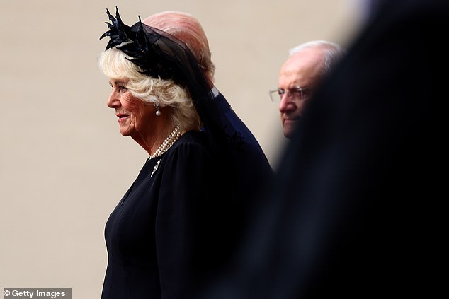 Queen Camilla is welcomed by officials at San Damaso Courtyard at Vatican City today